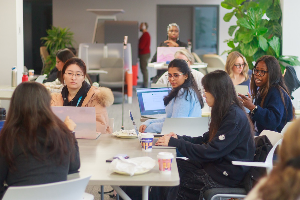 Participants building AI prototypes at the hackathon
